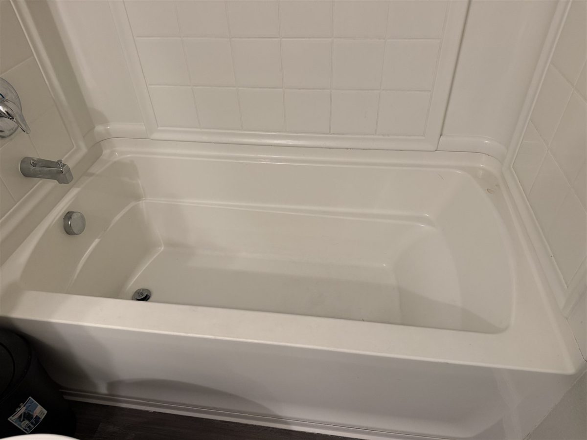 A bathtub and tile surround cleaned by Nook-N-Cranny Cleaning LLC on a Sacramento job